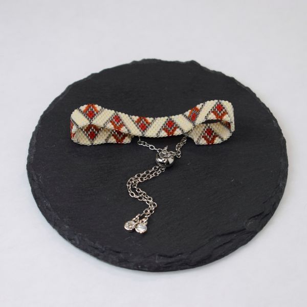 Red-beige bracelet with palladium corners