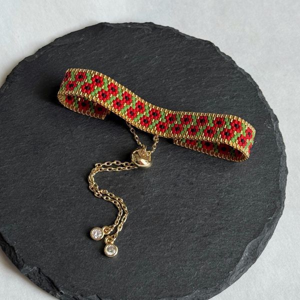 Red flower bracelet with gold